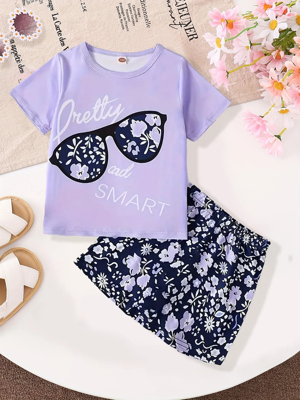 A Young Girl's Glasses And Fashionable T-Shirt Paired With A Floral Print Short Skirt Set, A Summer Trendy Children's Fashion Ou